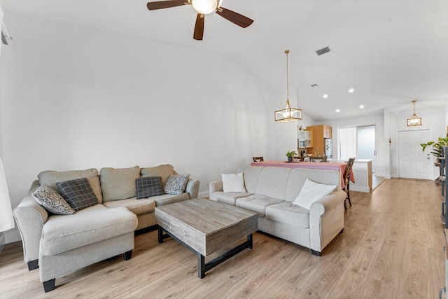 living area featuring vaulted ceiling, light wood finished floors, visible vents, ceiling fan, and recessed lighting