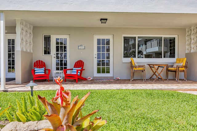 1199 Hillsboro Mile Unit 119, Hillsboro Beach, FL 33062 - rear view of house with a patio, stucco siding, and a yard