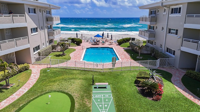 1199 Hillsboro Mile Unit 119, Hillsboro Beach, FL 33062 - pool with shuffleboard, a water view, fence, and a view of the beach