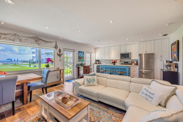 1199 Hillsboro Mile Unit 119, Hillsboro Beach, FL 33062 - living area featuring recessed lighting, visible vents, and light wood-type flooring