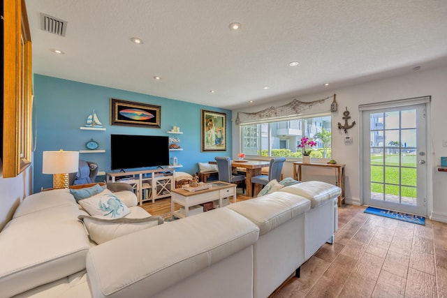 1199 Hillsboro Mile Unit 119, Hillsboro Beach, FL 33062 - living area featuring baseboards, recessed lighting, wood finished floors, and visible vents
