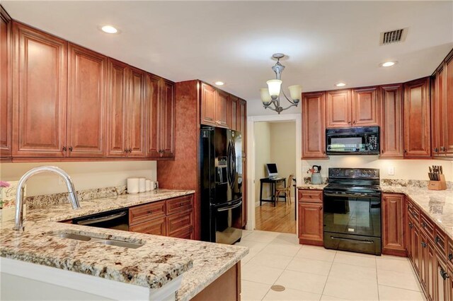 1090 31st Ave, Vero Beach, FL 32960 - kitchen with light stone countertops, a sink, black appliances, and visible vents