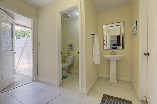 1090 31st Ave, Vero Beach, FL 32960 - bathroom with baseboards, toilet, and tile patterned flooring