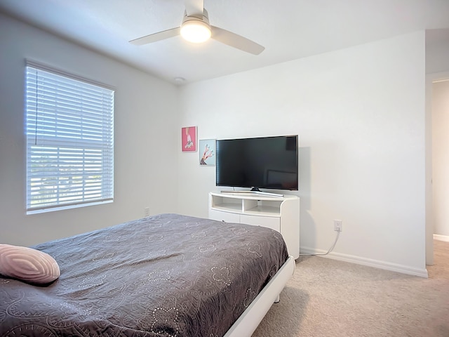carpeted bedroom featuring ceiling fan and baseboards