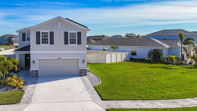 traditional home with fence, a front lawn, stucco siding, an attached garage, and driveway