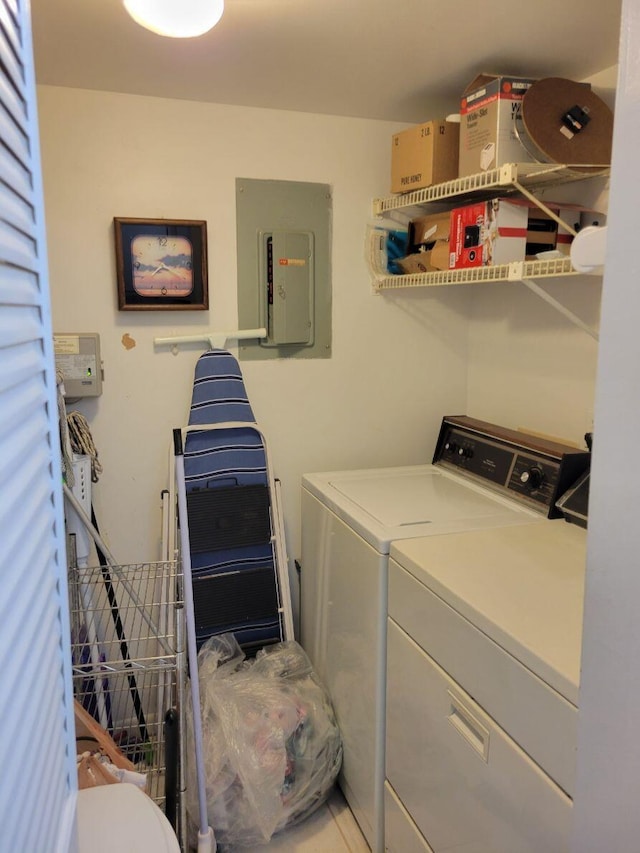 laundry room featuring washer and dryer, laundry area, and electric panel