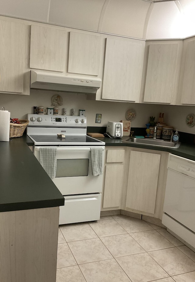 337 Knotty Pine Cir Unit B-1, Greenacres, FL 33463 - kitchen with white appliances, dark countertops, light brown cabinets, under cabinet range hood, and a sink