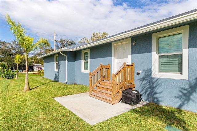 1200 Hartman Rd, Fort Pierce, FL 34947 - entrance to property featuring stucco siding, a yard, and a patio