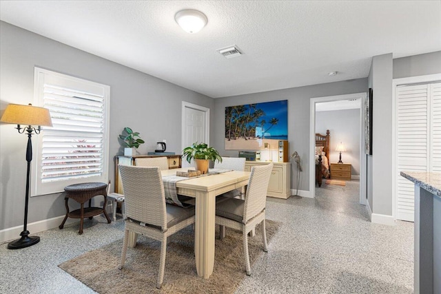 1200 Hartman Rd, Fort Pierce, FL 34947 - dining area featuring baseboards, dark speckled floor, and a textured ceiling