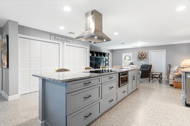 1200 Hartman Rd, Fort Pierce, FL 34947 - kitchen featuring island exhaust hood, gray cabinets, dark speckled floor, open floor plan, and a sink
