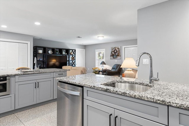 1200 Hartman Rd, Fort Pierce, FL 34947 - kitchen featuring stainless steel appliances, gray cabinetry, a sink, open floor plan, and recessed lighting