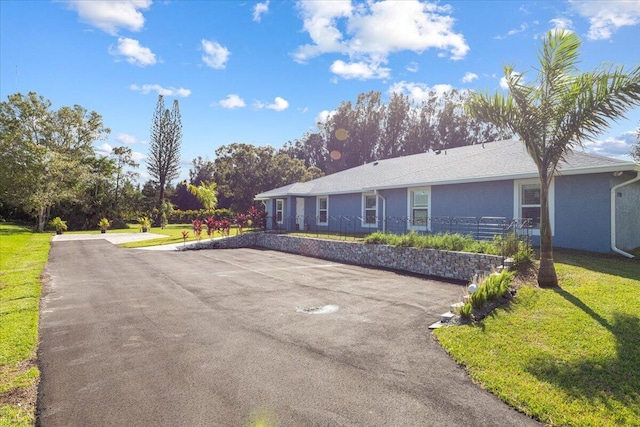 1200 Hartman Rd, Fort Pierce, FL 34947 - ranch-style house with a front lawn