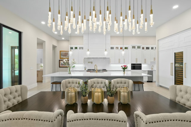 dining room featuring light wood-style flooring, baseboards, and recessed lighting