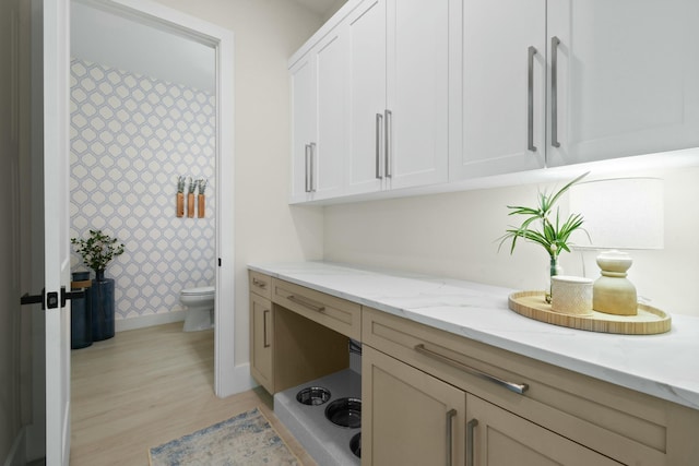 full bathroom featuring toilet, baseboards, wallpapered walls, wood finished floors, and vanity