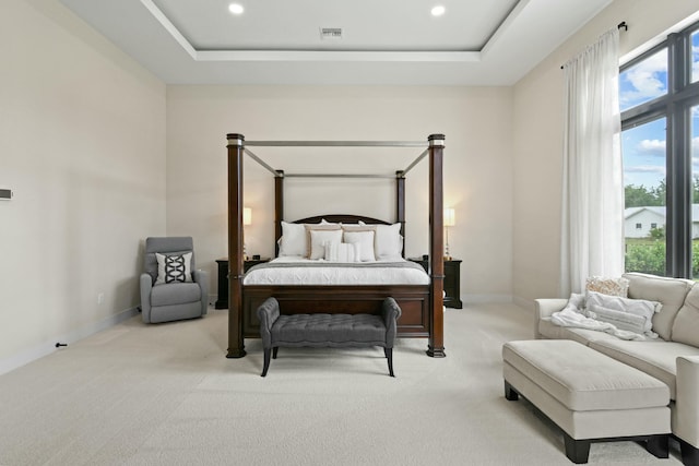 bedroom with baseboards, carpet flooring, recessed lighting, and a raised ceiling