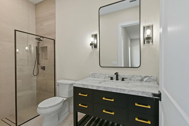 full bathroom with a shower stall, toilet, and vanity