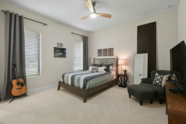 carpeted bedroom with baseboards and ceiling fan