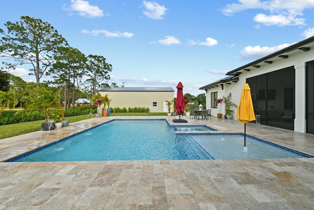 view of pool featuring a patio area and a pool with connected hot tub
