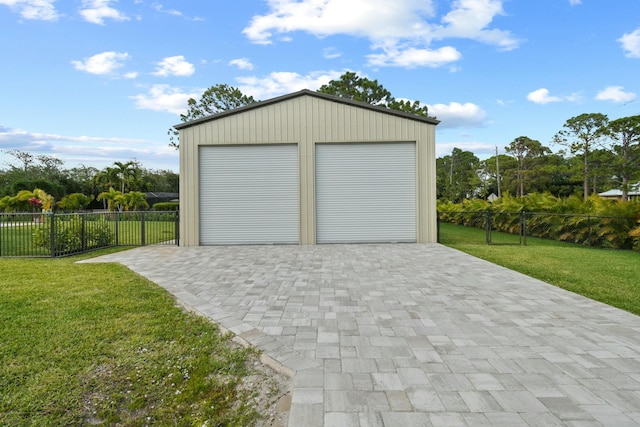 detached garage featuring fence