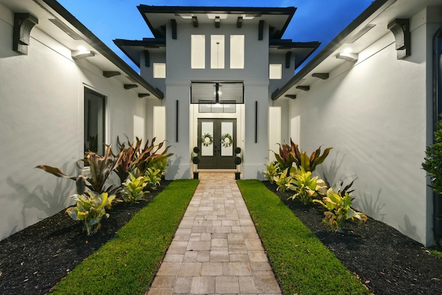 property entrance with french doors and stucco siding