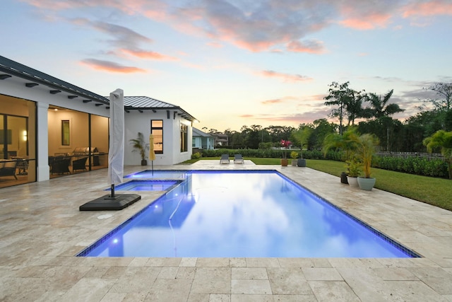 view of pool featuring a lawn, a fenced in pool, an in ground hot tub, and a patio