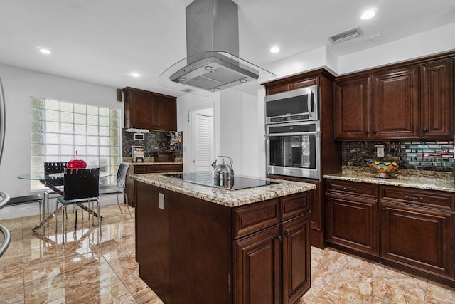 kitchen featuring appliances with stainless steel finishes, island exhaust hood, decorative backsplash, light stone countertops, and recessed lighting