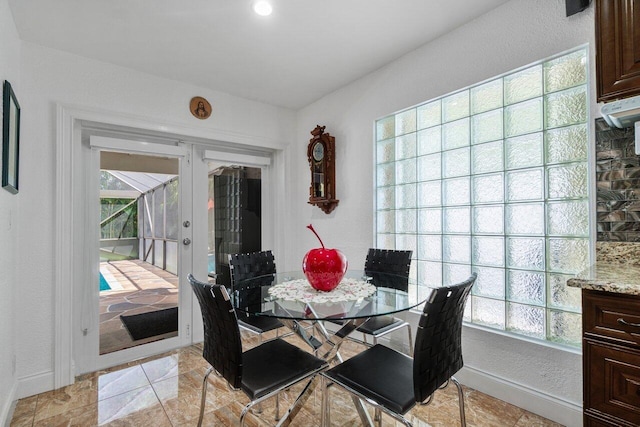 dining room featuring baseboards and french doors