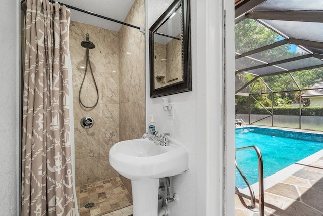 full bath with a shower stall, a textured wall, and stone finish flooring
