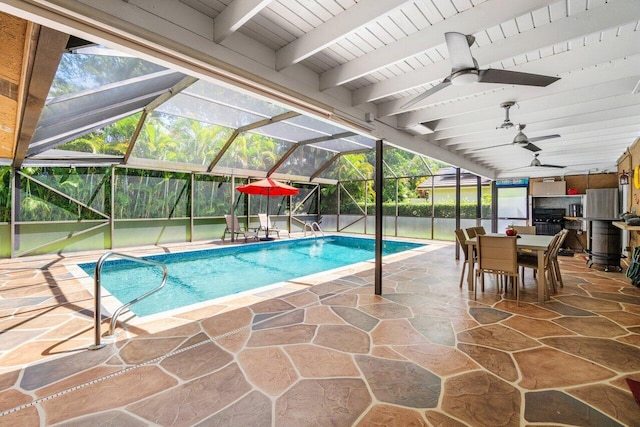 swimming pool featuring a patio area, a ceiling fan, outdoor dining space, and glass enclosure