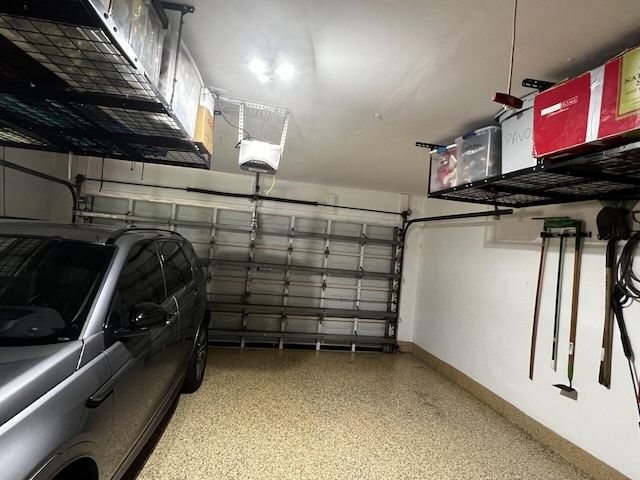 garage featuring baseboards and a garage door opener