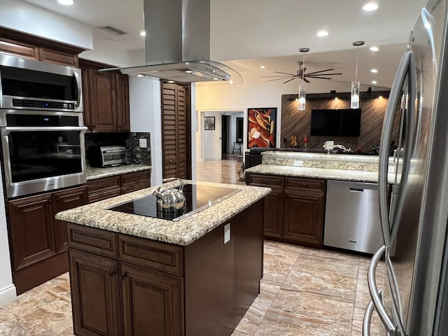 kitchen featuring appliances with stainless steel finishes, island range hood, a kitchen island, open floor plan, and ceiling fan