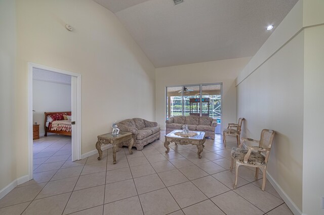 22234 Collington Dr, Boca Raton, FL 33428 - living room with high vaulted ceiling, light tile patterned floors, and baseboards