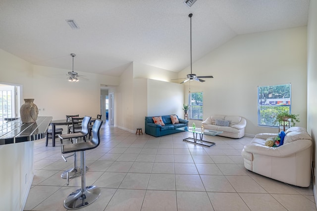 22234 Collington Dr, Boca Raton, FL 33428 - living area with ceiling fan, plenty of natural light, light tile patterned flooring, and high vaulted ceiling