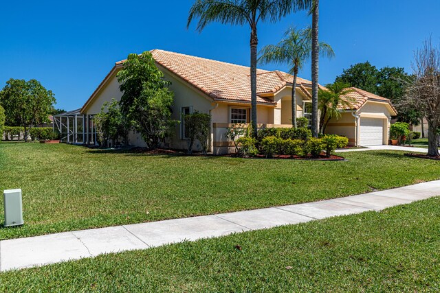 22234 Collington Dr, Boca Raton, FL 33428 - view of front of house featuring a tiled roof, a garage, stucco siding, a front lawn, and driveway