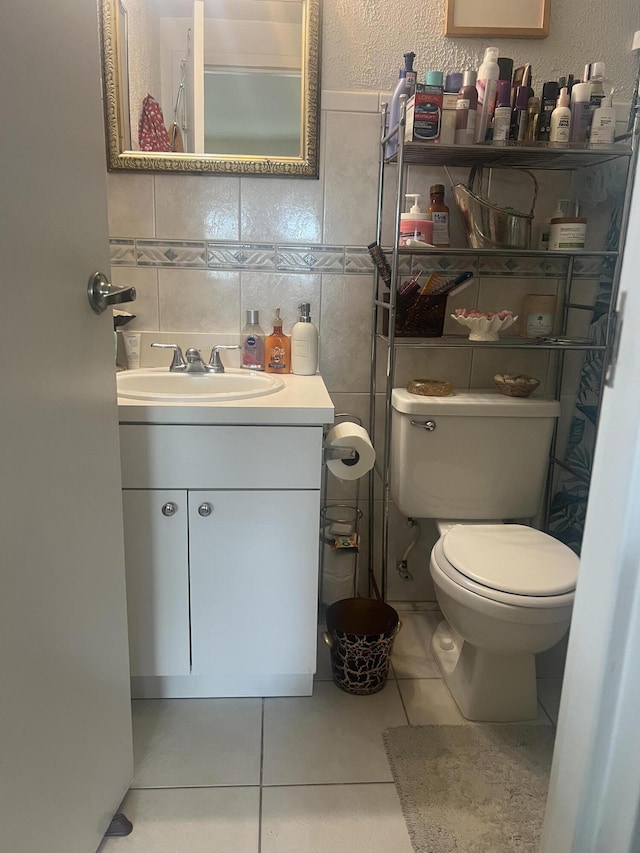 75 Flanders B B, Delray Beach, FL 33484 - half bath with tile patterned floors, toilet, tile walls, and vanity