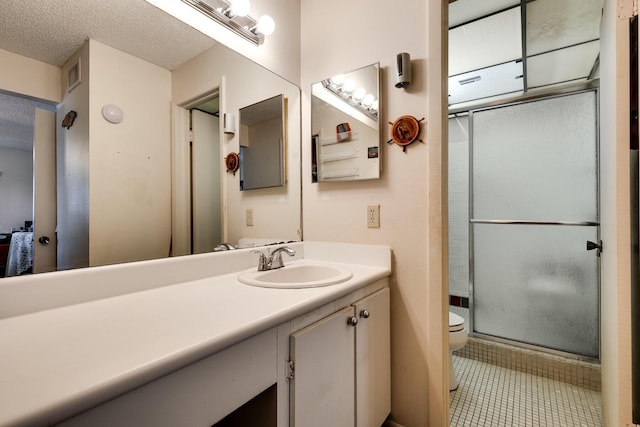 7612 Ashmont Cir Unit 203, Tamarac, FL 33321 - bathroom with vanity, toilet, a shower with shower door, a textured ceiling, and tile patterned flooring