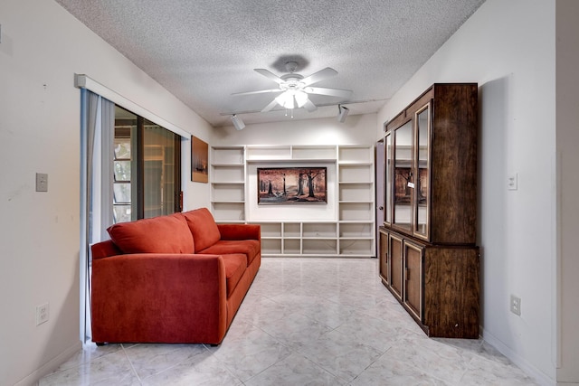7612 Ashmont Cir Unit 203, Tamarac, FL 33321 - living room featuring ceiling fan, a textured ceiling, and baseboards