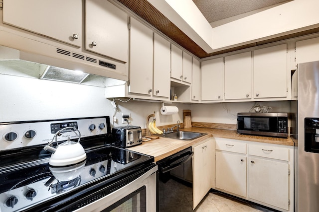 7612 Ashmont Cir Unit 203, Tamarac, FL 33321 - kitchen featuring stainless steel appliances, a sink, light countertops, under cabinet range hood, and white cabinets