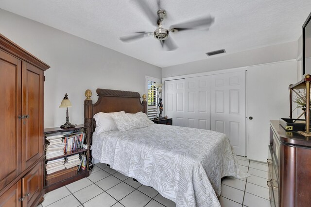 2211 NE 34th Ct, Lighthouse Point, FL 33064 - bedroom with visible vents, a ceiling fan, light tile patterned floors, and a closet