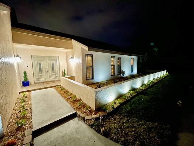 2211 NE 34th Ct, Lighthouse Point, FL 33064 - exterior entry at twilight with stucco siding