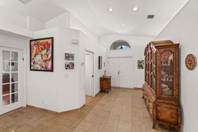 entrance foyer with recessed lighting, lofted ceiling, and visible vents