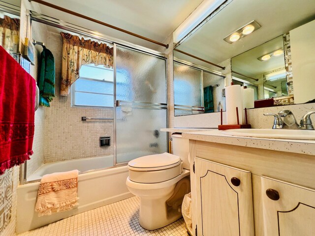 66 Andover C, West Palm Beach, FL 33417 - bathroom with tile patterned floors, toilet, enclosed tub / shower combo, and vanity