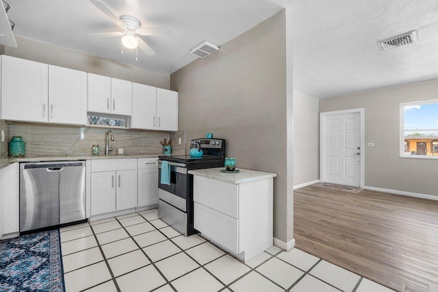 kitchen with a sink, visible vents, a ceiling fan, and appliances with stainless steel finishes