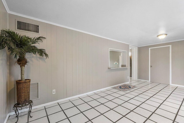 empty room with tile patterned flooring, crown molding, and visible vents
