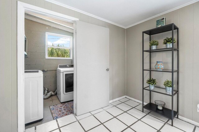washroom with washer and clothes dryer, laundry area, and ornamental molding