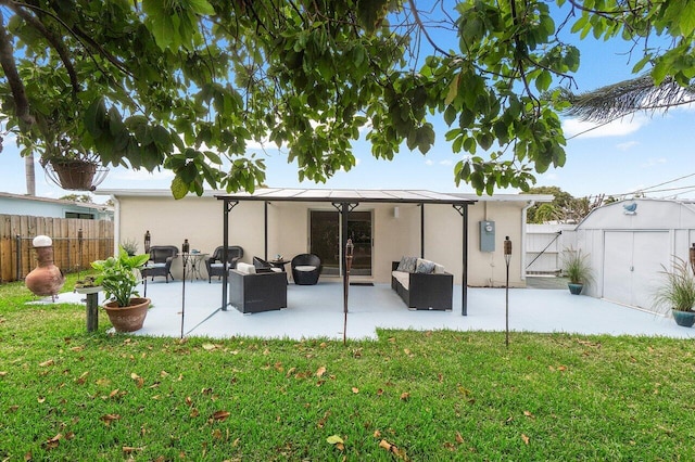 rear view of property featuring fence, a lawn, and a patio area