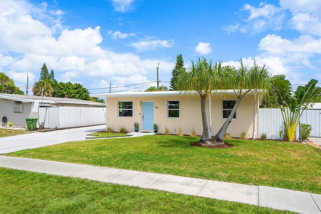 single story home featuring stucco siding, fence, and a front lawn
