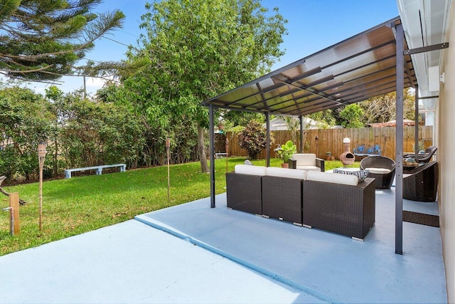 view of patio featuring an outdoor living space and fence