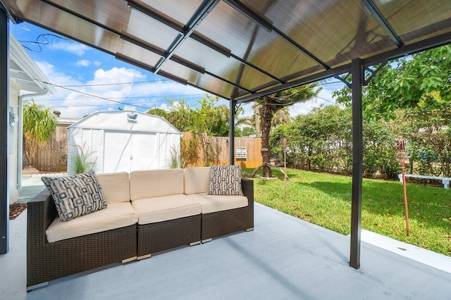 view of patio / terrace featuring an outdoor structure, a fenced backyard, a shed, and an outdoor living space