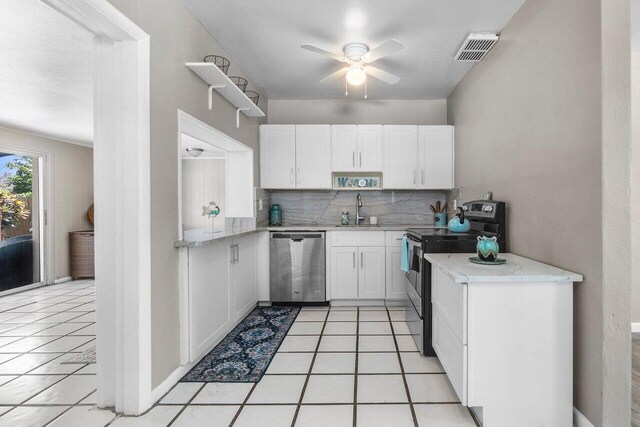 kitchen featuring white cabinets, a sink, stainless steel appliances, and visible vents